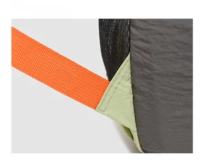 Macro shot of reinforced stitching on colorful outdoor backpack strap for durability