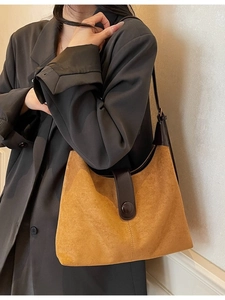 Brown suede hobo shoulder bag for women worn with a blazer for a stylish commuting look
