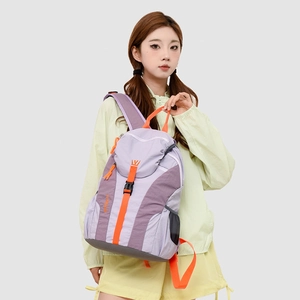 Close-up of lightweight outdoor travel backpack with purple color-blocking and orange accents