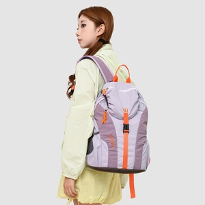 Detail view of lightweight lavender and orange outdoor backpack with mesh side pocket