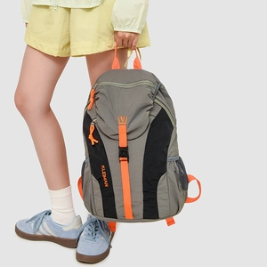 Detail of grey outdoor backpack featuring orange contrast straps and side mesh pocket