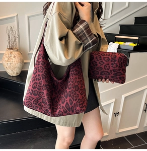 Detail of red leopard print tote bag and matching pouch set with soft fabric texture