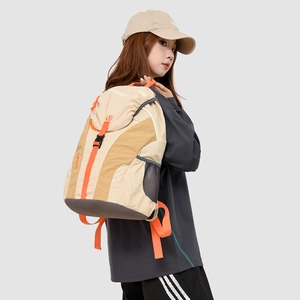Detail view of lightweight travel backpack featuring beige contrast and orange straps