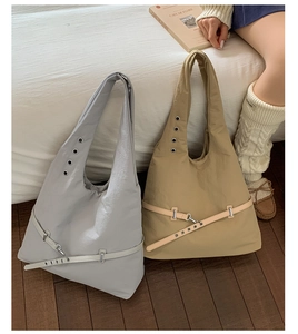 Detail of nylon hobo bags featuring metallic eyelet straps and decorative waist belts