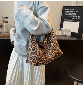 Fashionable leopard print tote bag styled for casual daily commuting in a cafe setting