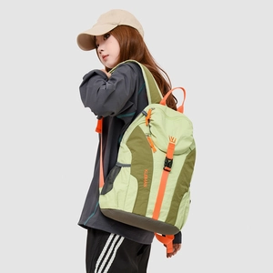 Detail of outdoor travel backpack featuring green color-blocking and orange zipper cords