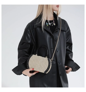 Rainbow woven box bag with metal rivets and chain strap styled on a black leather jacket