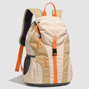 Detail of multi-color outdoor backpack featuring orange zipper cords and embroidered logo