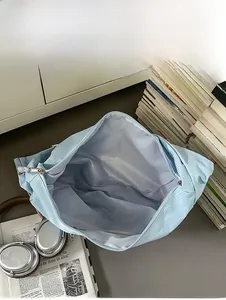 Internal capacity display of the spacious light blue checkered nylon crossbody bag