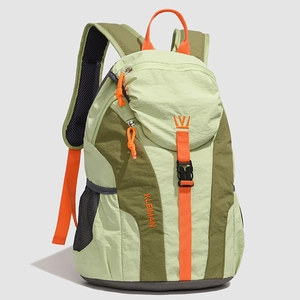 Detail of color-block lightweight nylon backpack showing side mesh pocket and texture