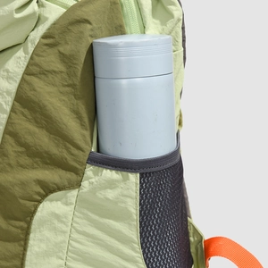 Close-up of lightweight nylon backpack side pocket with mesh pouch and water bottle