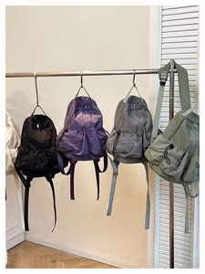 Detailed view of lightweight nylon outdoor backpacks in black, purple, grey and green