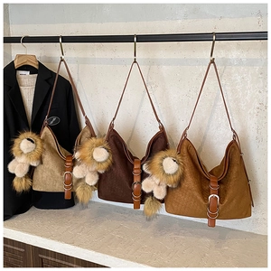 Suede bucket bags in khaki, brown and caramel with cute lion plush charms and metal buckles