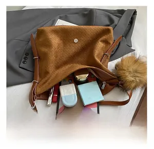 Detail view of large interior capacity for essentials in a brown woven tote bag