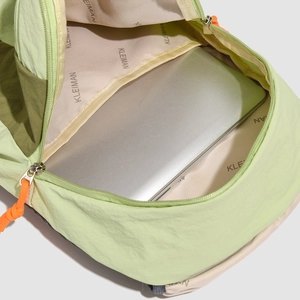 Detail view of the lightweight green travel backpack with padded laptop compartment