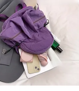 Detail of purple nylon backpack interior showing large capacity for essentials like umbrellas