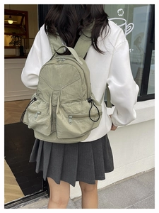 Outdoor leisure nylon backpack in light green showing back view with side pockets