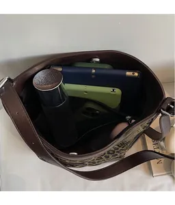 Top view of leopard canvas bucket bag interior holding a tablet and water bottle