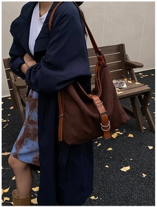Detail of vintage brown woven tote bag with adjustable leather straps in an autumn setting
