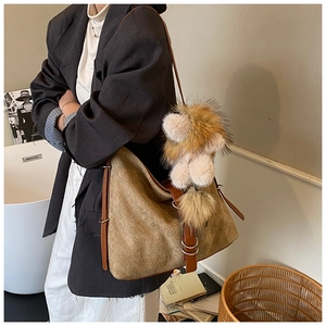 Retro khaki woven hobo bag with brown leather strap and large faux fur charm