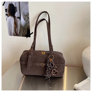 Detailed view of deep brown vintage leather pillow bag with silver metal buckles and straps