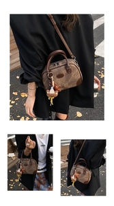 Detailed view of vintage brown patchwork pillow bag with bear and star charms