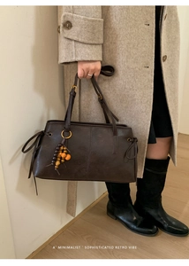 Retro brown leather shoulder bag with vintage wood bead charm and minimalist styling