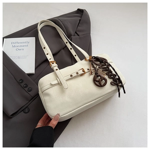 Close-up of creamy white shoulder bag featuring premium leather texture and gold hardware details