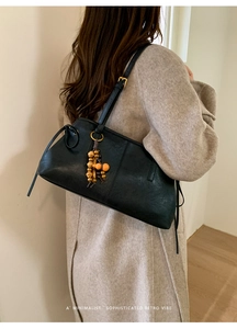 Retro black minimalist underarm bag featuring a vintage wooden bead charm accessory