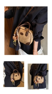 Detail view of retro patchwork pillow bag with brown leather handles and bear pendant