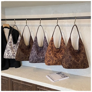 Collection of five vintage paisley pattern tote bags in assorted warm earthy colors