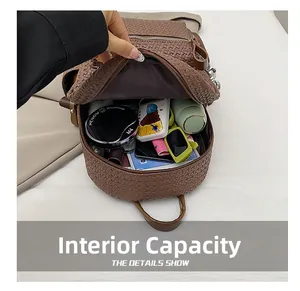 Detail view of a woven leather backpack interior showing large storage capacity and items