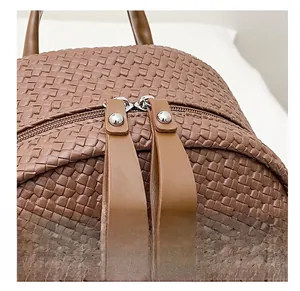 Detailed macro view of brown woven leather texture with high quality double metal zippers