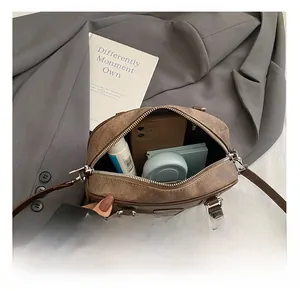 Detailed view of the spacious interior compartment of the brown patchwork pillow bag