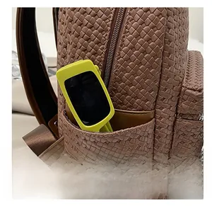 Detailed close-up of the woven leather texture and practical side pocket of the brown backpack