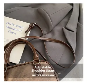 Detailed close-up of the adjustable shoulder strap and vintage PU leather texture