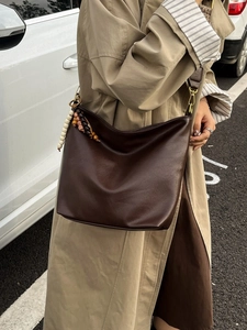 Brown soft leather hobo bucket bag with ethnic beaded tassel charm for women