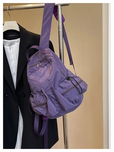 Close-up of purple nylon backpack showing tear-resistant fabric texture and zipper details