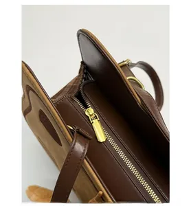 Close-up of smooth gold metal zipper and striped lining on cute brown cat backpack
