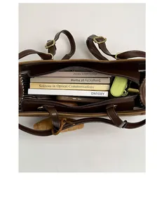 Interior view of the dark brown tote bag showing multiple compartments and large capacity