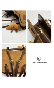 Close-up of brown suede backpack with golden zipper detail and croissant plush charm