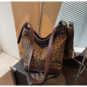 Detail of leopard print hobo bag showing adjustable leather strap and textured fabric