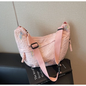 Detailed close-up of pink hobo bag featuring 3D diamond texture and butterfly embroidery