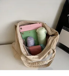 Interior view of large capacity beige canvas tote bag showing tablets and daily essentials