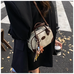 Retro khaki canvas boston bag with dark brown leather trim and hanging star charm