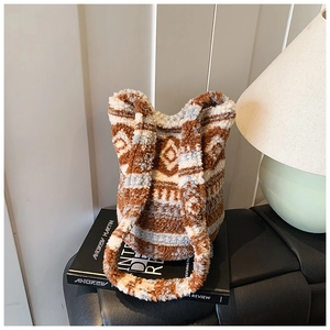 Close-up of ethnic geometric pattern on soft sherpa bucket bag with plush texture details