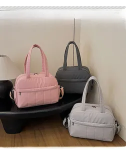 Three colors of large travel nylon bags in pink, dark gray, and light gray