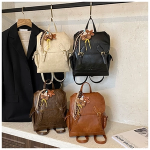 Four vintage PU leather backpacks in beige black brown and tan with bear charms