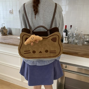 Detailed back view of a khaki cat-shaped backpack with a plush croissant charm on a model