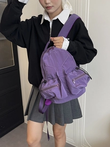Water-resistant purple nylon backpack with multi-pocket design for outdoor sports and students